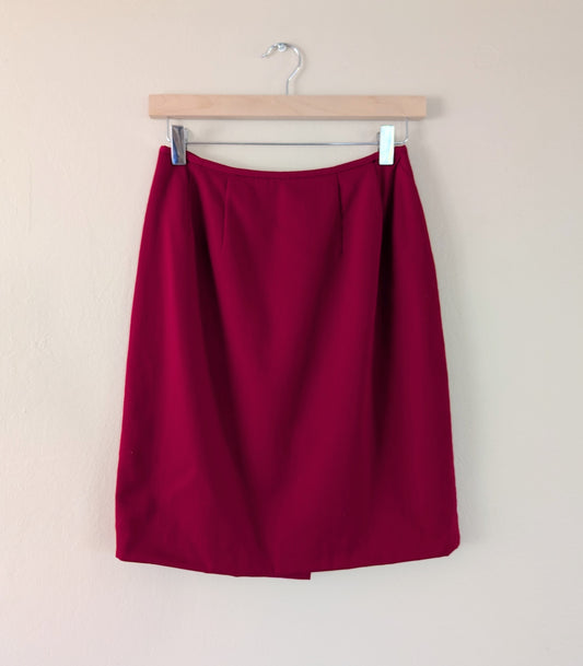red wool pencil skirt on hanger against white background