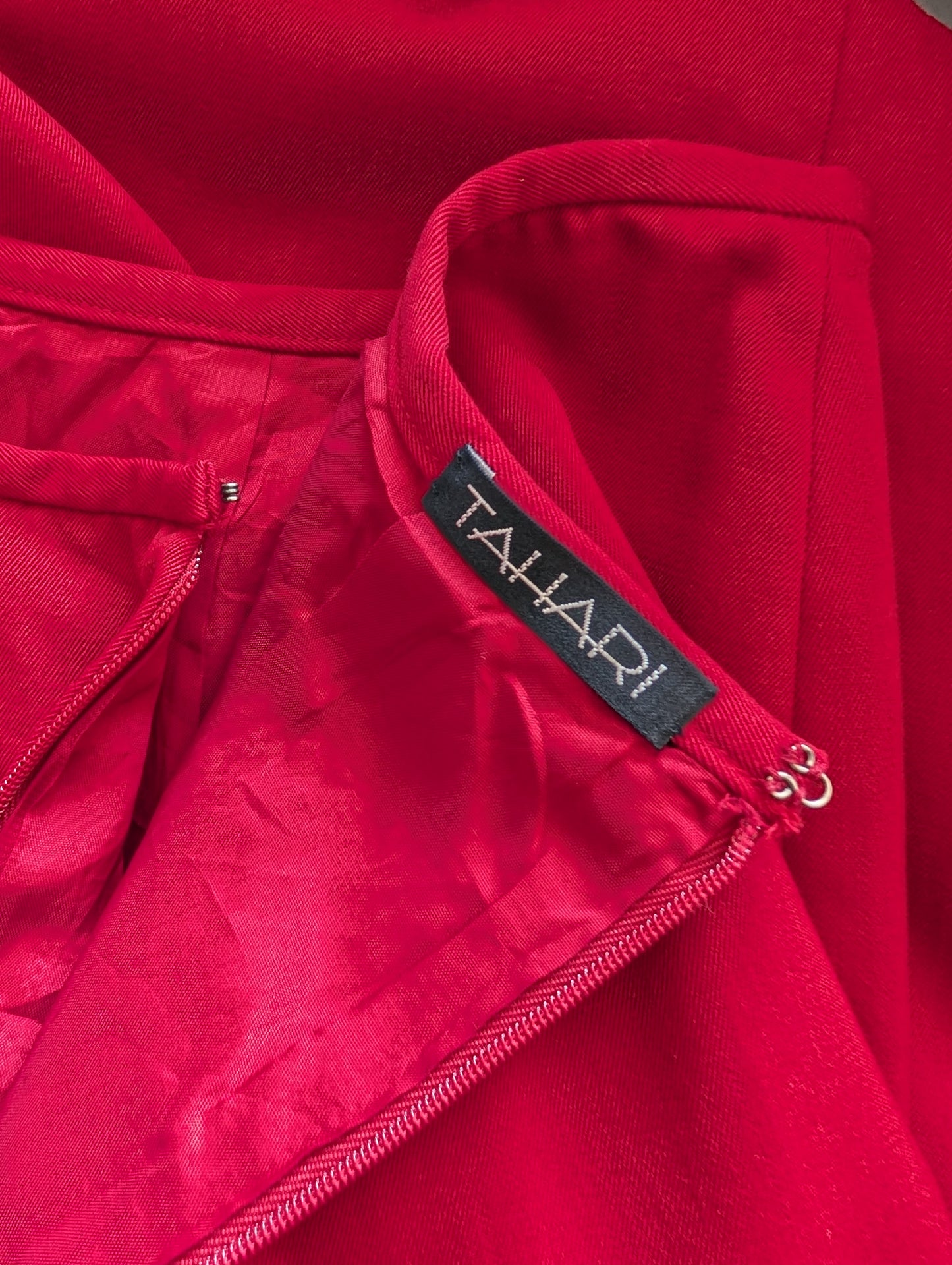 Close-up of a red garment with a Tahari label.