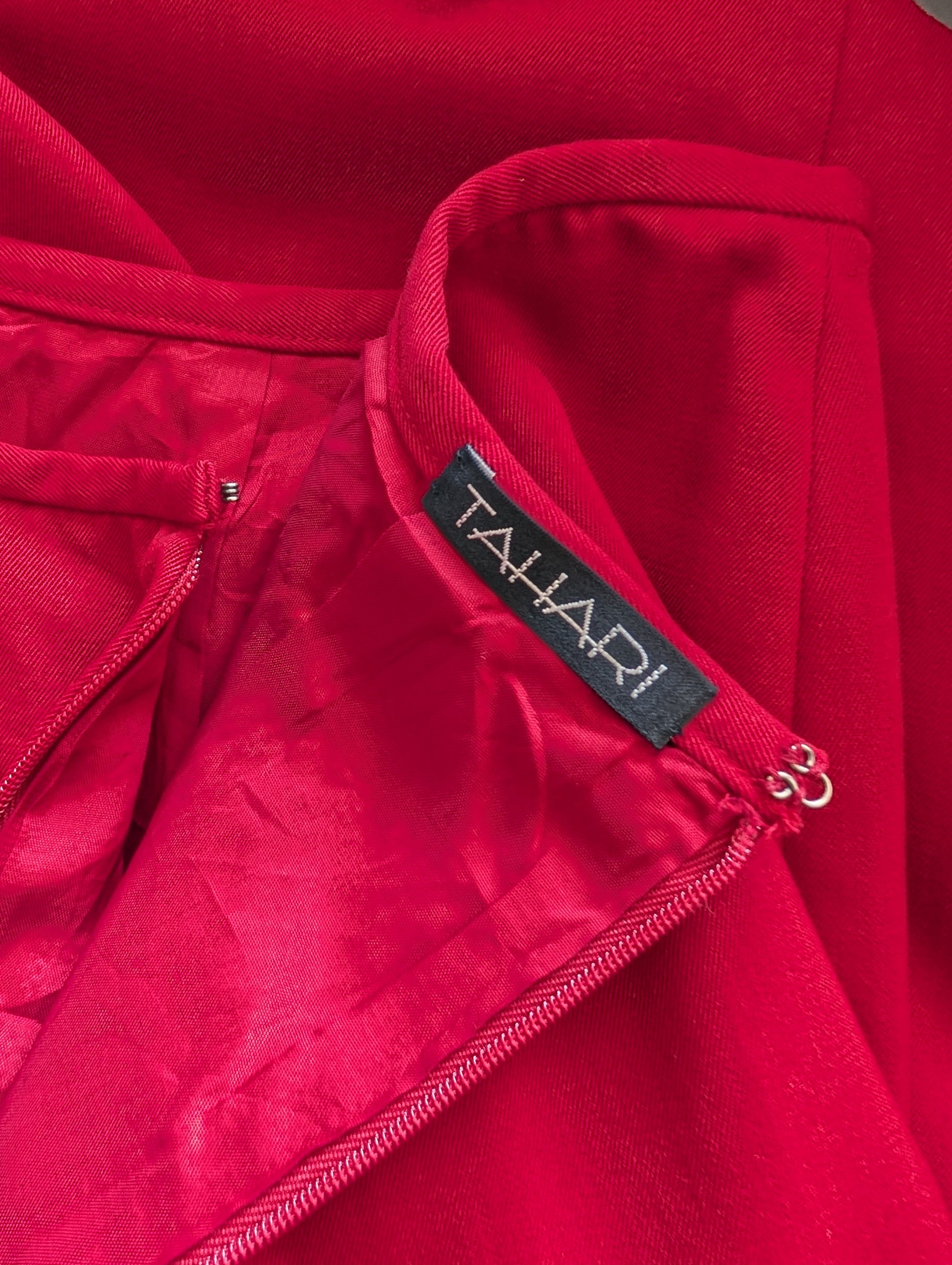 Close-up of a red garment with a Tahari label.