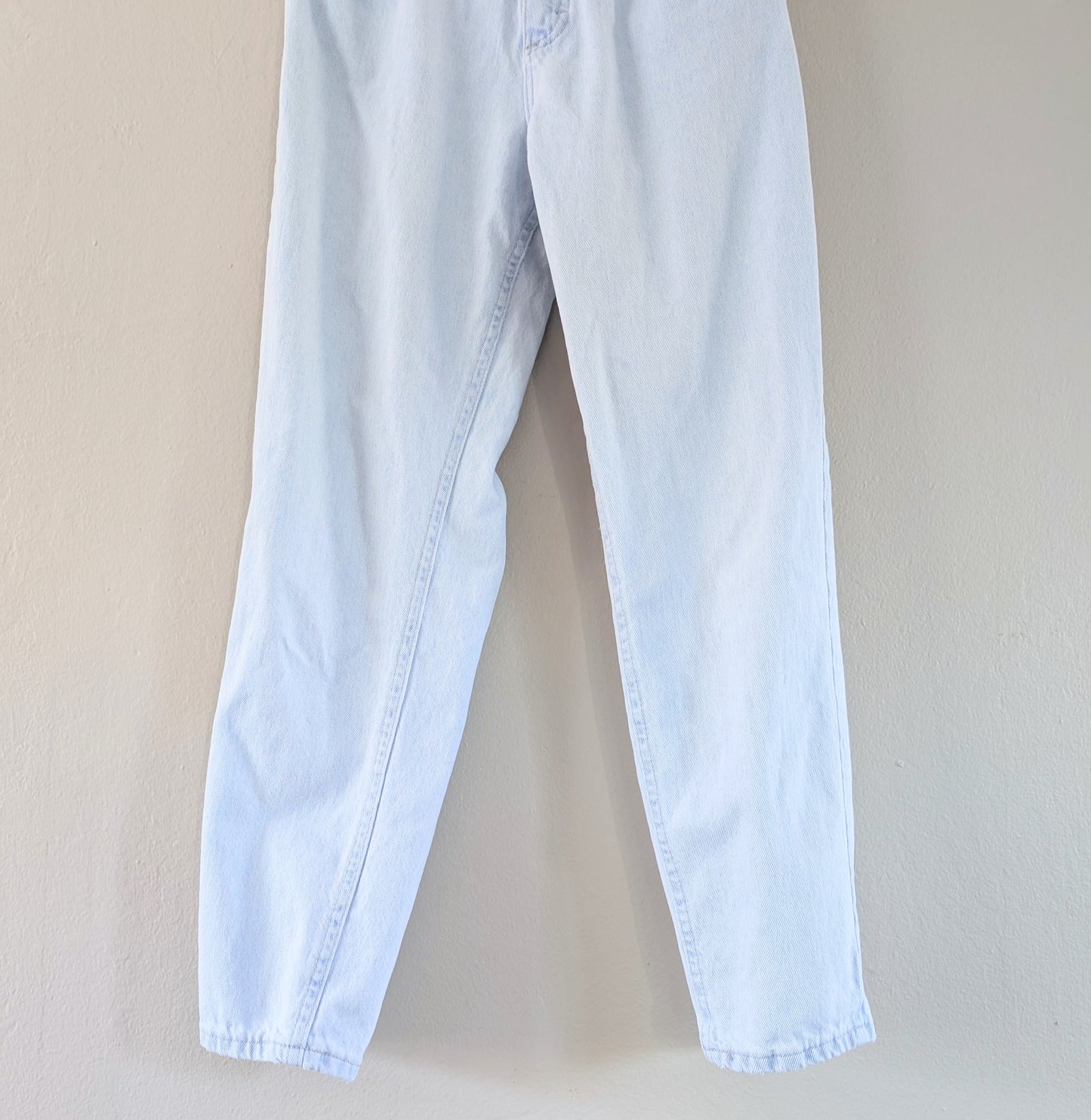 Light blue jeans on a beige background