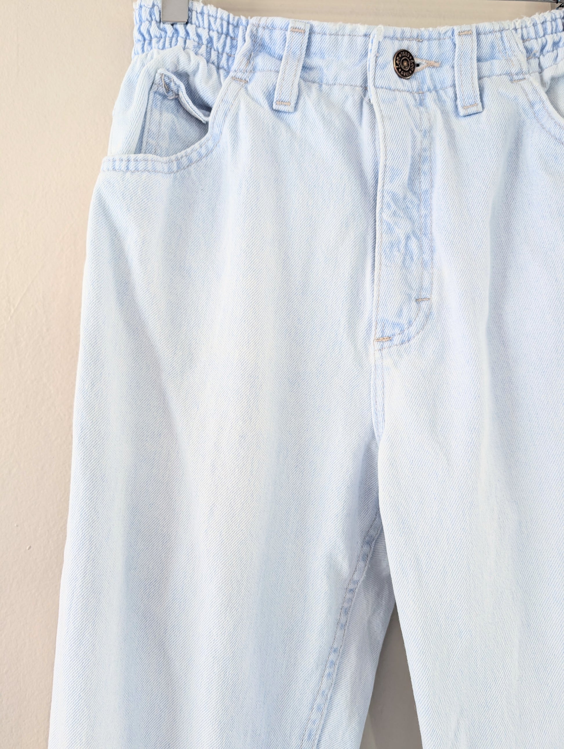 Light blue jeans on a beige background