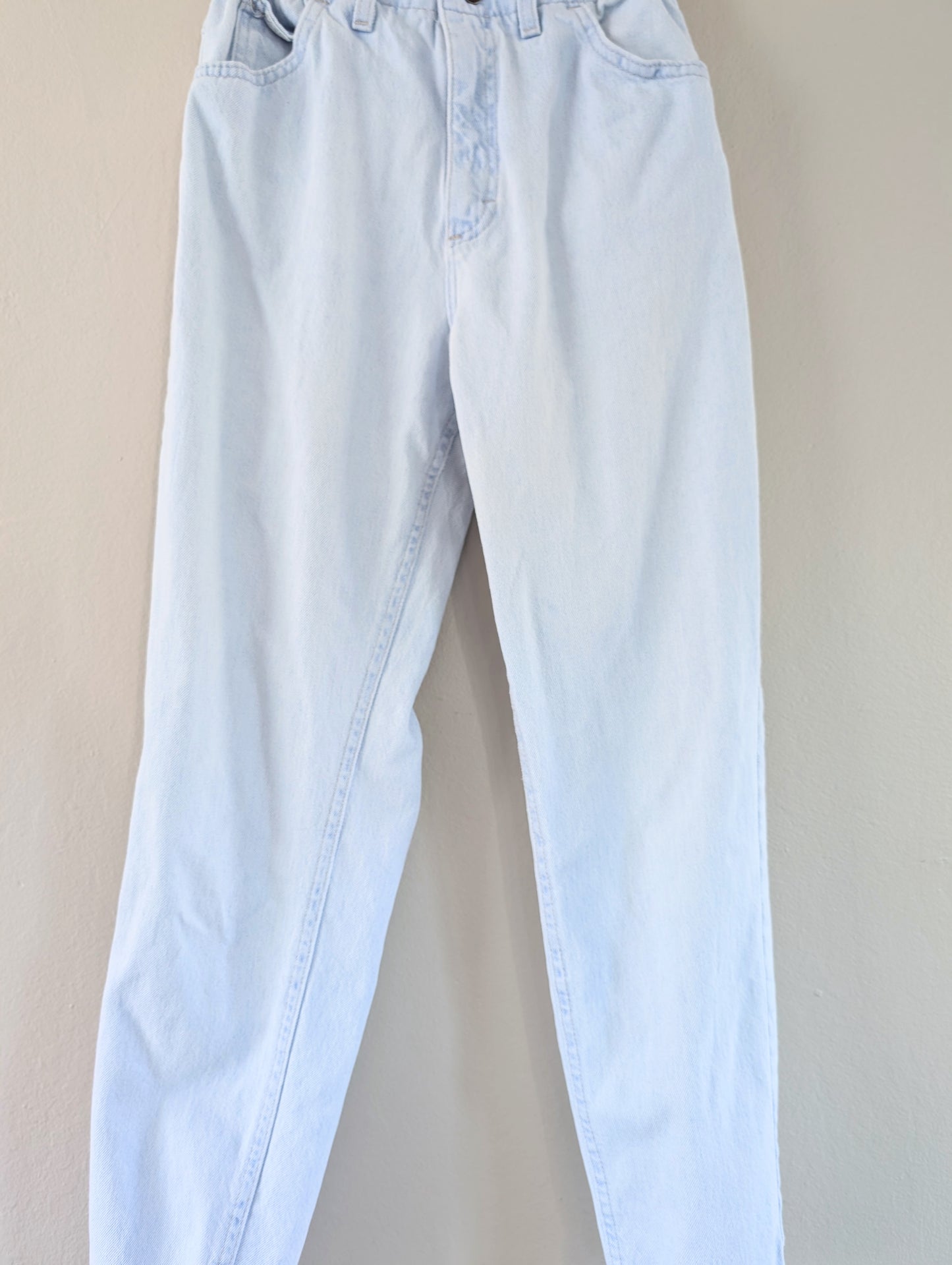 Light blue jeans on a beige background